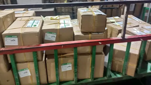 Strapped export cartons labelled for London Heathrow on the cargo trolley